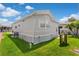 Well-kept exterior with gray siding, manicured lawn, and modern utilities at 3333 26Th E Ave # 1090, Bradenton, FL 34208