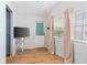 Cozy living room featuring wood-look floors, a wall-mounted TV, and natural light from large windows at 3333 26Th E Ave # 1090, Bradenton, FL 34208
