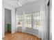 Bright sun room featuring white walls, wood-look floors, and large windows with sheer curtains at 3333 26Th E Ave # 1090, Bradenton, FL 34208