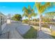 Backyard with a canal view, a paved patio, palm trees, and well-maintained landscaping at 4059 Orient Dr, Hernando Beach, FL 34607