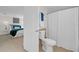 Bathroom with white toilet, shower with a white curtain, and bedroom view at 4059 Orient Dr, Hernando Beach, FL 34607