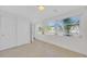 Bright bedroom with large windows, tile floors, and a closet with folding doors at 4059 Orient Dr, Hernando Beach, FL 34607