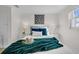 Comfortable bedroom showcasing a queen-sized bed with blue pillows and an emerald throw at 4059 Orient Dr, Hernando Beach, FL 34607