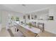 Bright dining room featuring a wooden table, neutral chairs, and open access to the kitchen at 4059 Orient Dr, Hernando Beach, FL 34607