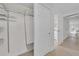 Hallway leading to multiple rooms with white doors and tile flooring at 4059 Orient Dr, Hernando Beach, FL 34607