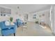 Inviting living room with modern furnishings, light wood floors, and cozy blue armchairs at 4059 Orient Dr, Hernando Beach, FL 34607