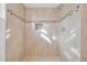 Tiled shower featuring a shower head, a built-in niche, and decorative mosaic accents at 4059 Orient Dr, Hernando Beach, FL 34607