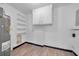 Utility room with a water heater, storage shelves, and cabinets for organization at 4059 Orient Dr, Hernando Beach, FL 34607