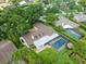 Aerial view of property featuring screened-in pool, lush landscaping, and neutral roof at 4209 Winding Willow Dr, Tampa, FL 33618