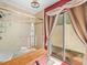 Tile shower with glass door and curtains leading to the backyard at 4209 Winding Willow Dr, Tampa, FL 33618