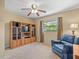 Bedroom featuring built-in cabinets, ceiling fan, large window, and blue recliner at 4209 Winding Willow Dr, Tampa, FL 33618