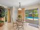Charming dining area with a glass table, comfortable chairs, and views of the backyard pool area offering a great view at 4209 Winding Willow Dr, Tampa, FL 33618