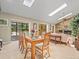 A dining room connects to the living room and features sliding doors to the pool area providing a bright, airy feel at 4209 Winding Willow Dr, Tampa, FL 33618