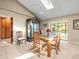 Dining room with glass-top table, cabinet, and sliding glass doors leading to a pool area providing natural light at 4209 Winding Willow Dr, Tampa, FL 33618