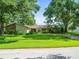 Well-maintained home with lush front lawn and mature trees provides great curb appeal at 4209 Winding Willow Dr, Tampa, FL 33618