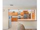 Open kitchen featuring wood cabinetry, stainless steel appliances, and granite countertops providing a stylish cooking space at 4209 Winding Willow Dr, Tampa, FL 33618