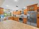 Bright kitchen features stainless steel appliances, wood cabinets, and an island overlooking a lush backyard at 4209 Winding Willow Dr, Tampa, FL 33618