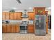 Spacious kitchen features stainless steel appliances and wooden cabinets for a functional and appealing space at 4209 Winding Willow Dr, Tampa, FL 33618