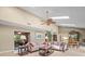 Spacious living room featuring skylights, ceiling fan, and comfortable seating at 4209 Winding Willow Dr, Tampa, FL 33618