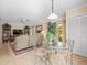 Relaxing living room with a glass top table, a large TV, and sliding glass doors with pool views, great for relaxing at 4209 Winding Willow Dr, Tampa, FL 33618
