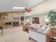 Spacious living room with a stone fireplace, skylight, and large windows that create an open, airy feel at 4209 Winding Willow Dr, Tampa, FL 33618