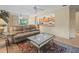 Inviting living room featuring comfortable seating, a glass-top coffee table, and an open view into the kitchen at 4209 Winding Willow Dr, Tampa, FL 33618