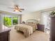 The main bedroom features a ceiling fan, neutral walls, and an expansive window overlooking greenery at 4209 Winding Willow Dr, Tampa, FL 33618