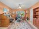 Spacious home office with a ceiling fan, a desk, and large area rug at 4209 Winding Willow Dr, Tampa, FL 33618