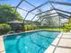 Screened-in pool featuring a splash fountain and an adjacent cabana at 4209 Winding Willow Dr, Tampa, FL 33618
