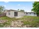 Back exterior featuring a concrete patio and screened-in pool area and view of the home at 4414 Royal Oak Ln, New Port Richey, FL 34653