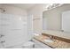 Bathroom showcasing shower-tub combo, vanity with granite countertop, toilet and built-in shelves at 4414 Royal Oak Ln, New Port Richey, FL 34653