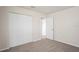 Bright bedroom with neutral walls and carpeting featuring a closet and an entry doorway at 4414 Royal Oak Ln, New Port Richey, FL 34653