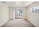 A carpeted room with sliding glass doors to an outdoor patio area offers great natural light at 4414 Royal Oak Ln, New Port Richey, FL 34653
