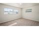 Bedroom with neutral carpet and windows offers a blank canvas for relaxation and personalization at 4414 Royal Oak Ln, New Port Richey, FL 34653