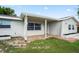 Inviting front porch with brick accents and neutral tones, creating a warm and welcoming entrance at 4414 Royal Oak Ln, New Port Richey, FL 34653