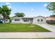 Charming single-story home features a well-maintained lawn and a classic, neutral-toned exterior at 4414 Royal Oak Ln, New Port Richey, FL 34653