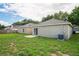 Expansive backyard showcasing the home's exterior, including a concrete patio and air conditioning unit at 456 Summer Sails Dr, Valrico, FL 33594