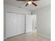 Bedroom view showing closet, bathroom entrance, neutral paint, tile flooring and ceiling fan at 456 Summer Sails Dr, Valrico, FL 33594