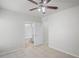 Bright bedroom featuring neutral walls and tile floors, leading into an ensuite bathroom at 456 Summer Sails Dr, Valrico, FL 33594