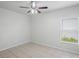 Well-lit bedroom with tile flooring, a ceiling fan, and a window overlooking the outdoors at 456 Summer Sails Dr, Valrico, FL 33594
