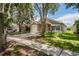 Attractive home with a well-manicured lawn, a driveway, and mature trees in a residential neighborhood at 456 Summer Sails Dr, Valrico, FL 33594
