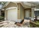 Home featuring an attached garage and a welcoming front entryway with well-maintained landscaping at 456 Summer Sails Dr, Valrico, FL 33594