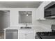 Modern kitchen featuring stainless steel appliances, white cabinetry, and a pass through window at 456 Summer Sails Dr, Valrico, FL 33594