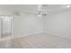 Open-concept living room boasts neutral tile flooring, a ceiling fan, and seamless transition to other spaces at 456 Summer Sails Dr, Valrico, FL 33594