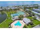 Aerial view of community including tennis courts, swimming pool, clubhouse, and landscaping at 4984 Beach Se Dr # B, St Petersburg, FL 33705