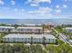 An aerial view of a waterfront residential community with boat docks on a canal and bay in background at 4984 Beach Se Dr # B, St Petersburg, FL 33705