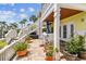 Backyard with brick patio, stairs to second floor, and water views at 4984 Beach Se Dr # B, St Petersburg, FL 33705