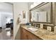 Elegant bathroom with granite countertop vanity, ornate mirror, and ensuite bathroom with walk-in shower at 4984 Beach Se Dr # B, St Petersburg, FL 33705
