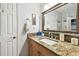 Elegant bathroom featuring granite countertop vanity, decorative mirror, and well-placed towel accents at 4984 Beach Se Dr # B, St Petersburg, FL 33705