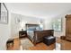 Spacious bedroom with hardwood floors, large bed, and ample natural light from the window with shutters at 4984 Beach Se Dr # B, St Petersburg, FL 33705